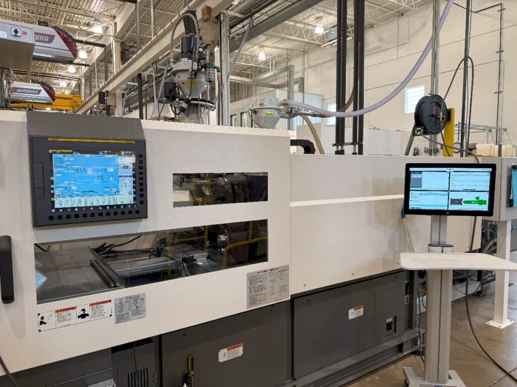 Scientific injection molding process control screen displaying real-time data for precision quality control in Cadillac, Michigan.